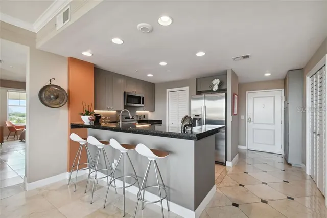 a kitchen with stainless steel appliances kitchen island granite countertop a sink and cabinets
