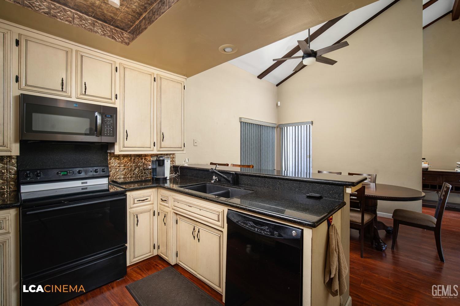Undisclosed Address Bakersfield, CA 93309 - Photo 12 of 30 a kitchen with stainless steel appliances a stove sink and cabinets