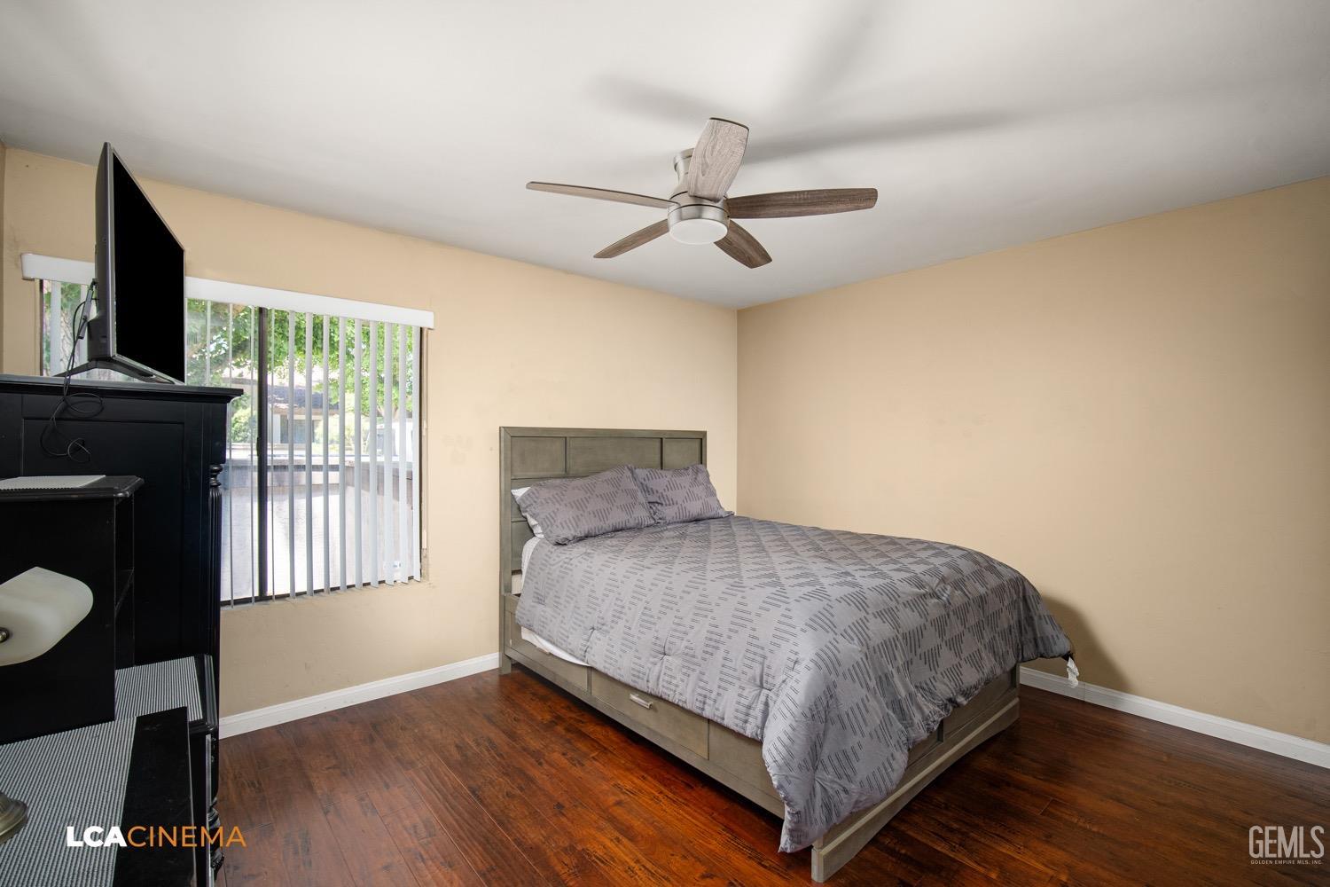 Undisclosed Address Bakersfield, CA 93309 - Photo 13 of 30 a bedroom with a bed a fireplace and a flat tv