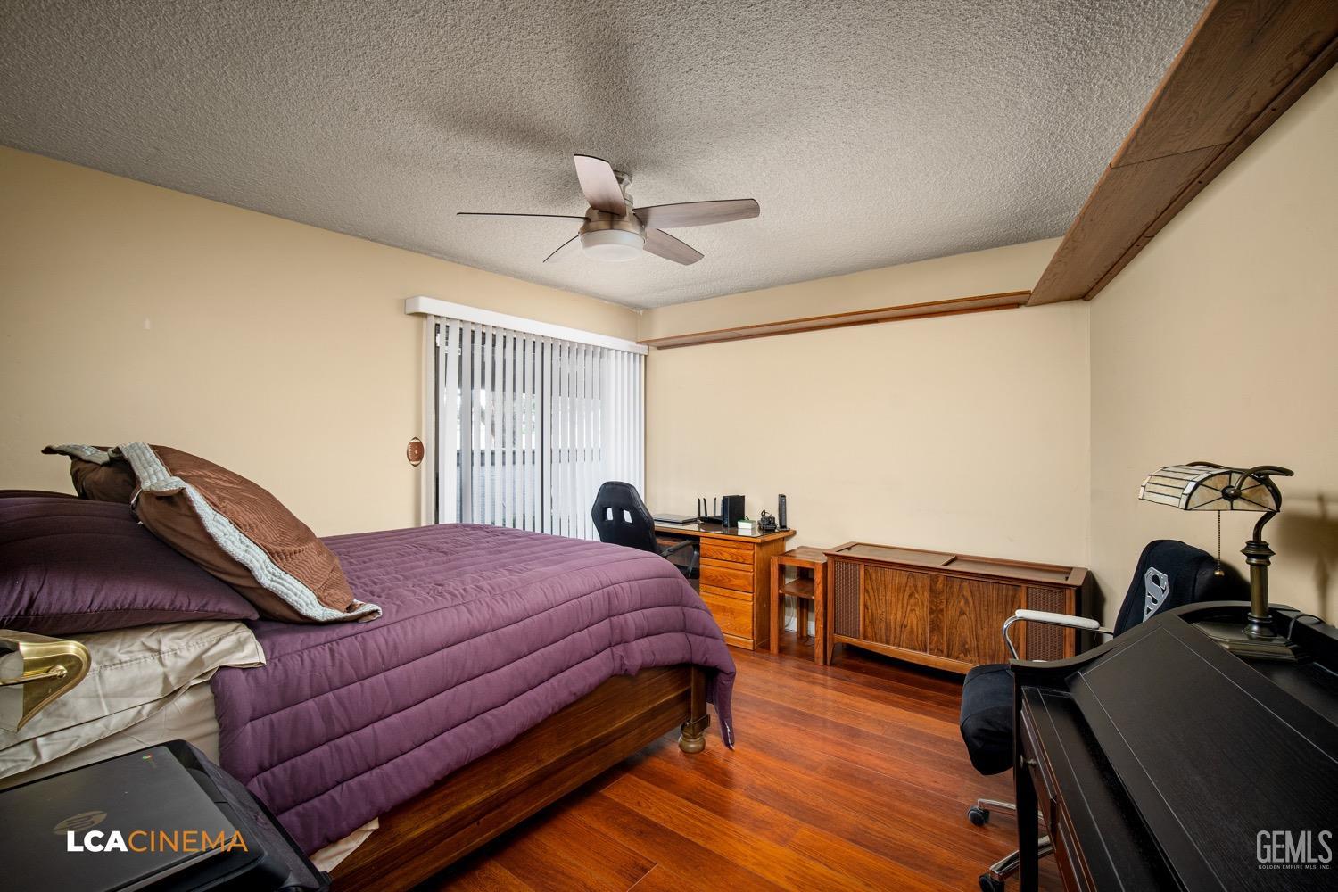 Undisclosed Address Bakersfield, CA 93309 - Photo 15 of 30 a bedroom with furniture and wooden floor