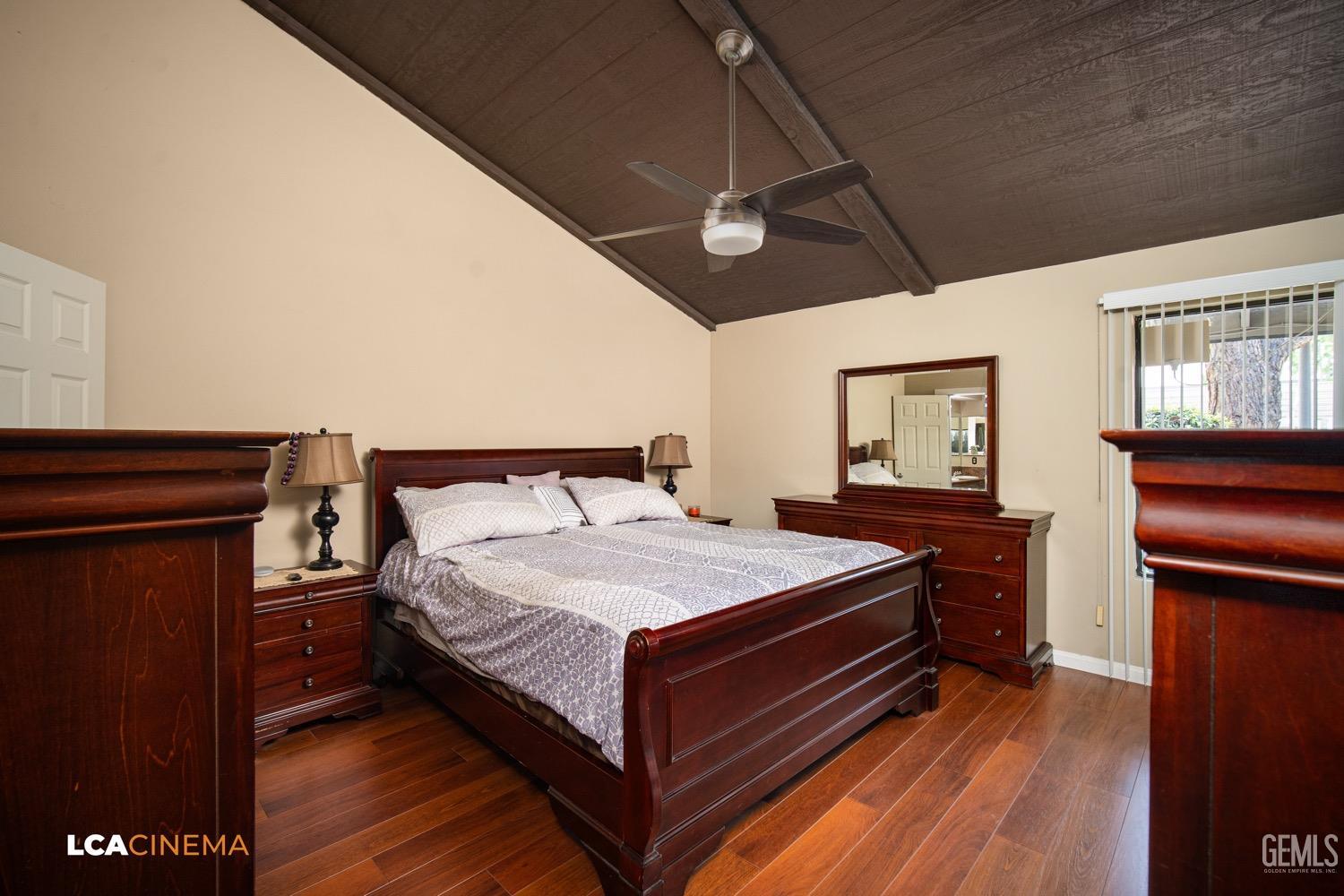 Undisclosed Address Bakersfield, CA 93309 - Photo 16 of 30 a bedroom with a bed and wooden floor