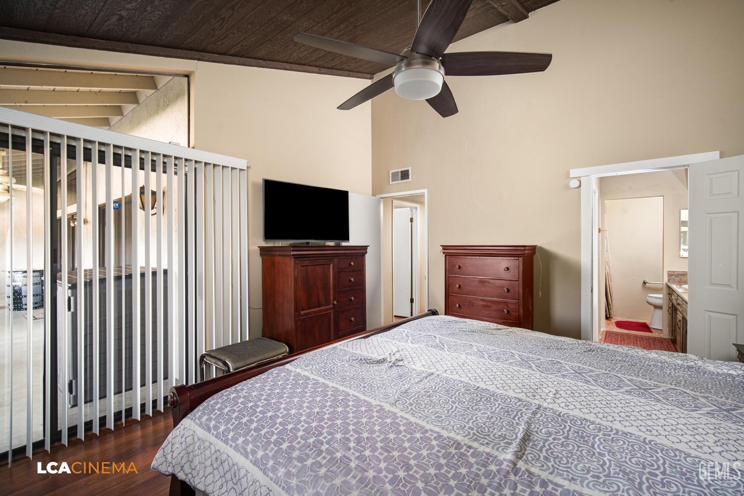 Undisclosed Address Bakersfield, CA 93309 - Photo 17 of 30 a bedroom with a bed and a flat tv screen on dresser