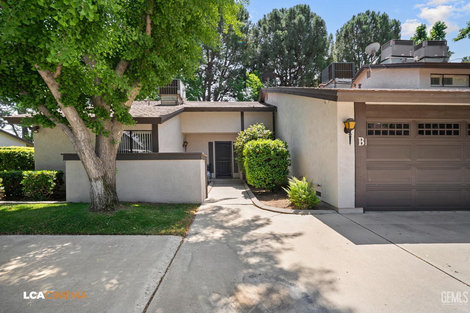 Undisclosed Address Bakersfield, CA 93309 - Photo 2 of 30 a front view of a house with garden