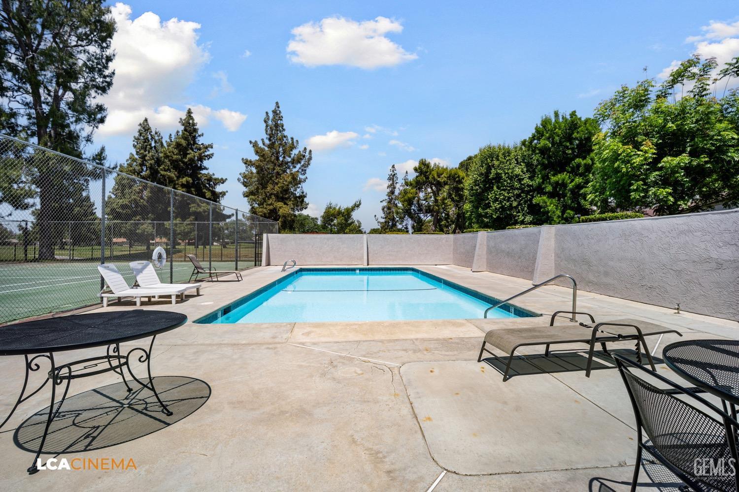 Undisclosed Address Bakersfield, CA 93309 - Photo 26 of 30 a view of a swimming pool with a patio and a yard