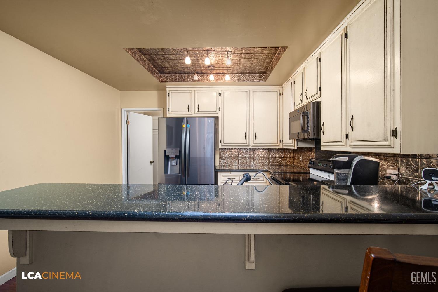 Undisclosed Address Bakersfield, CA 93309 - Photo 8 of 30 a kitchen with stainless steel appliances granite countertop a sink a refrigerator and a granite counter tops