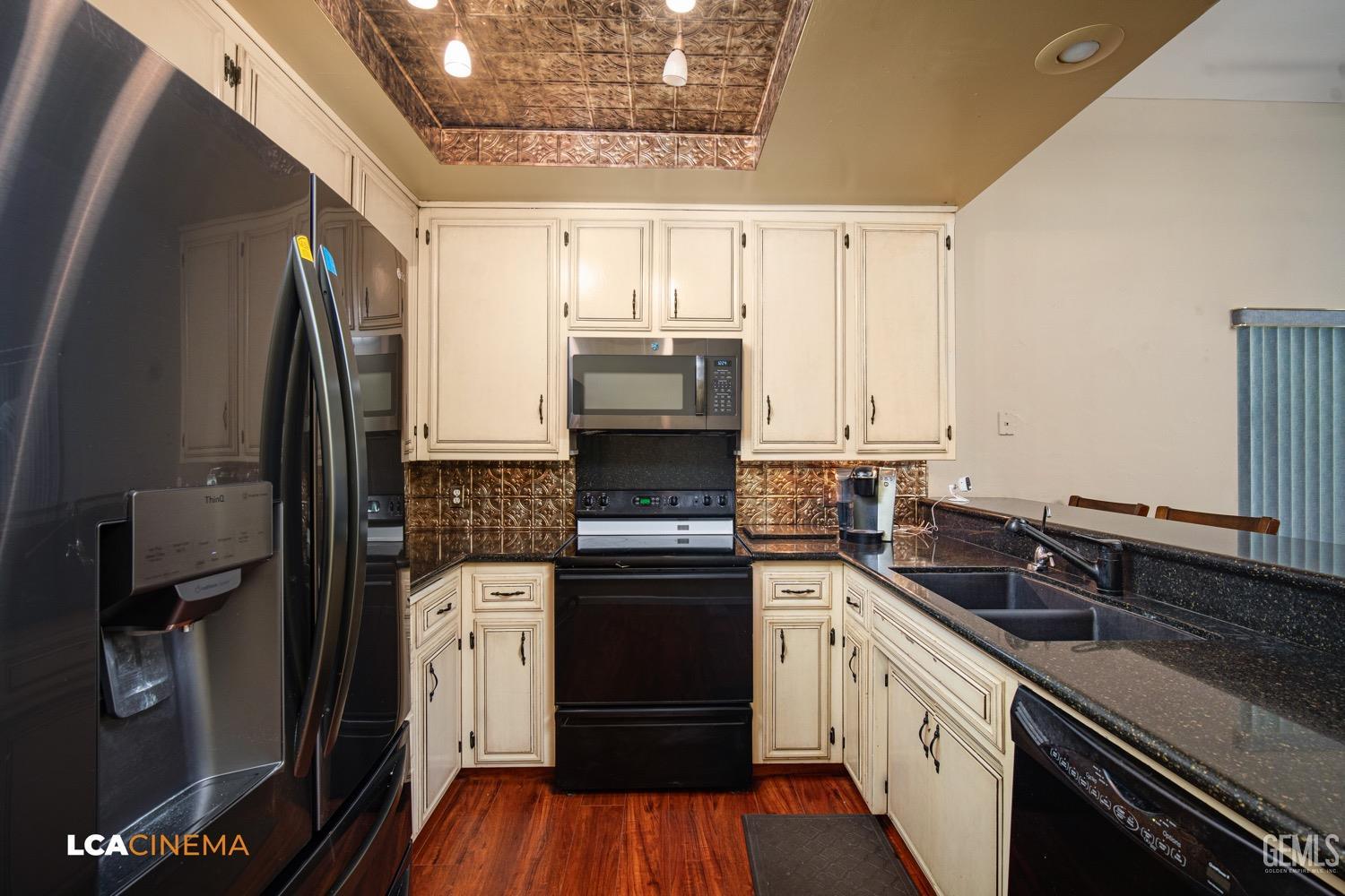Undisclosed Address Bakersfield, CA 93309 - Photo 10 of 30 a kitchen with granite countertop a refrigerator oven and sink