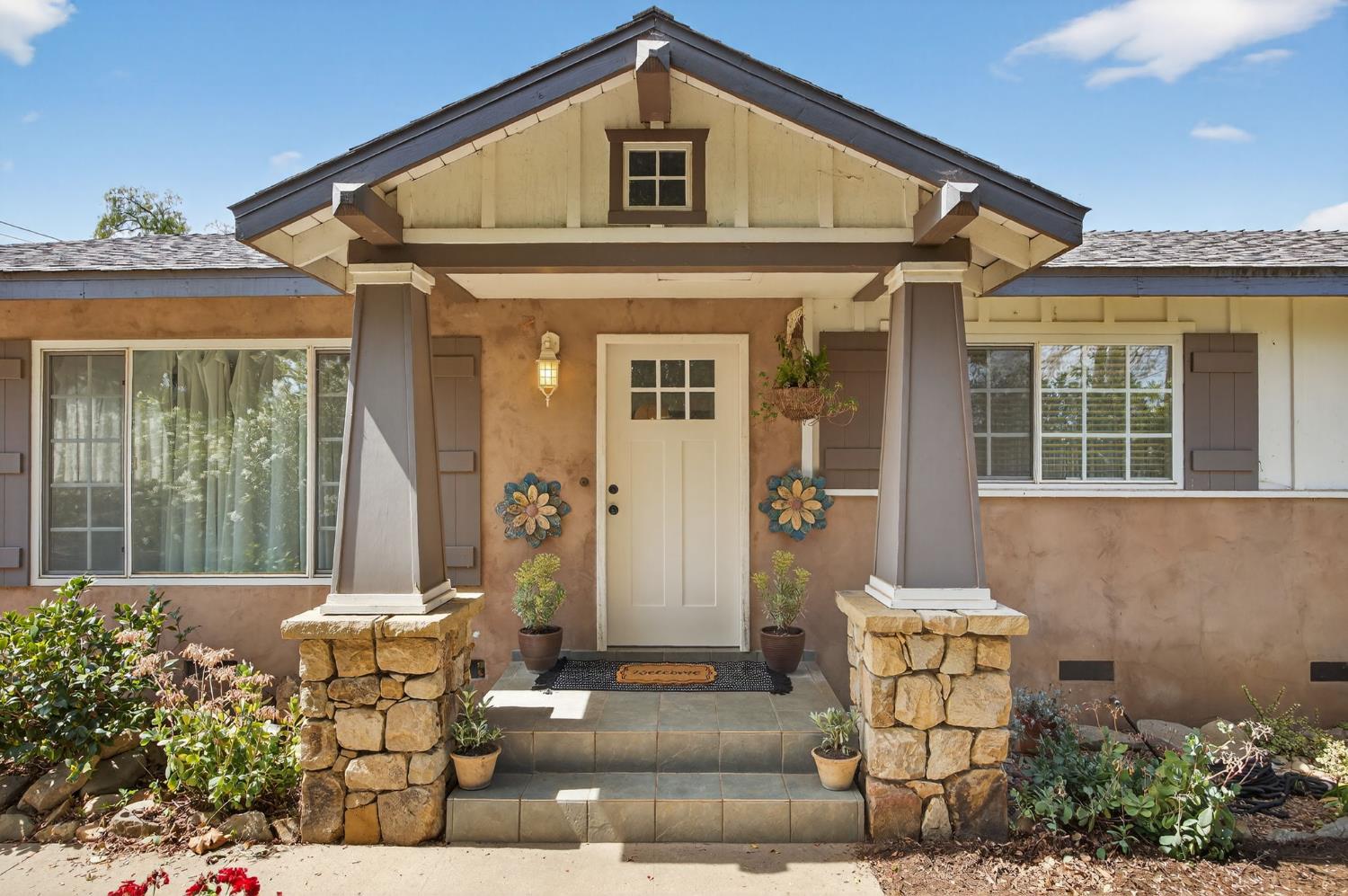 a front view of a house with garden