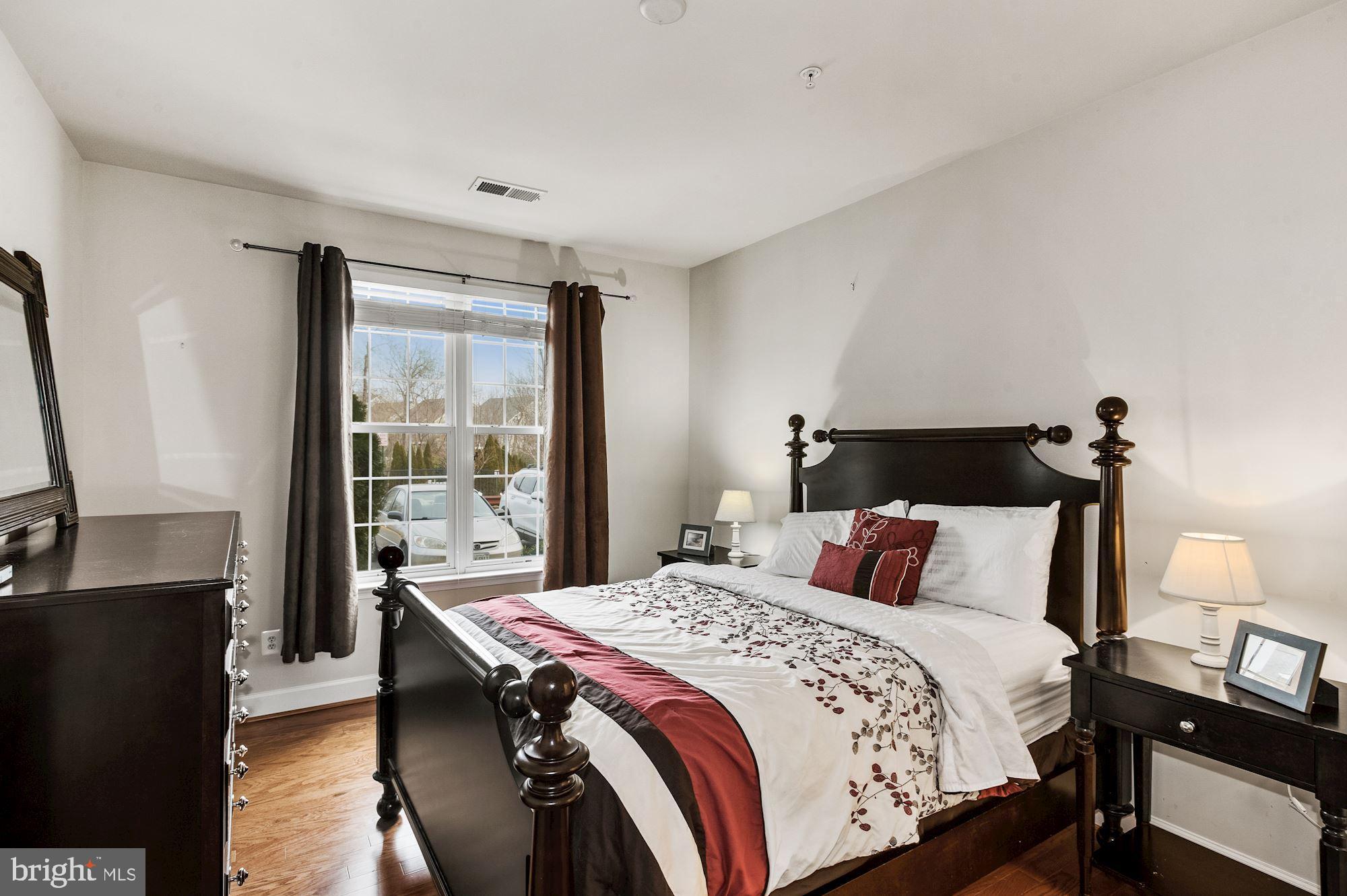 7065 Heritage Hunt Drive, Unit 101 Gainesville, VA 20155 - Photo 16 of 36 More wood floors in primary bedroom.