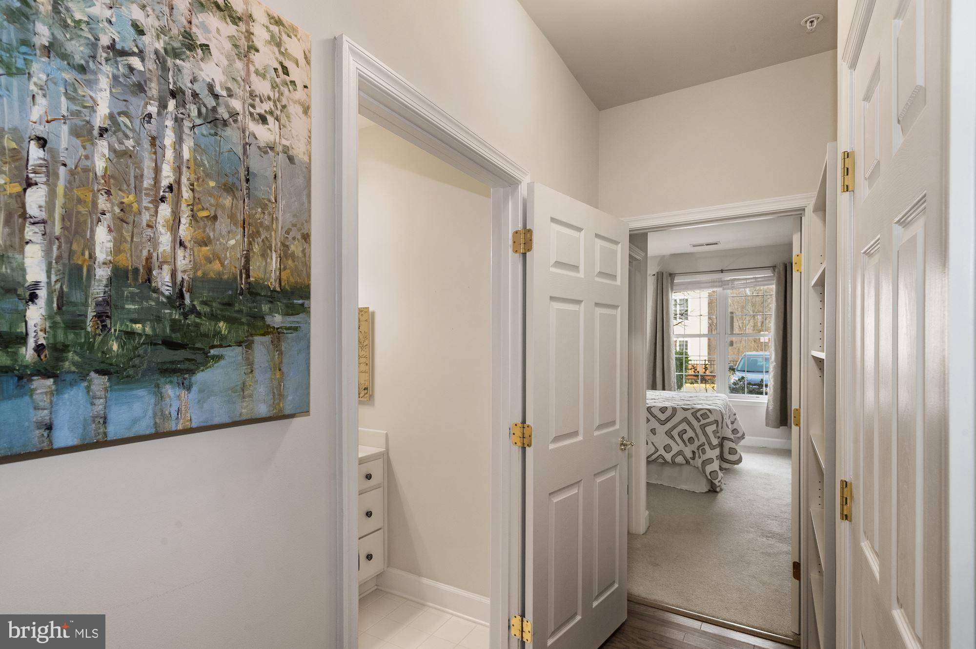 7065 Heritage Hunt Drive, Unit 101 Gainesville, VA 20155 - Photo 20 of 36 Wood floor hallway to 2nd bedroom/bathroom.