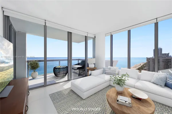a living room with furniture and a large window