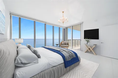 a bedroom with a bed tv and a window