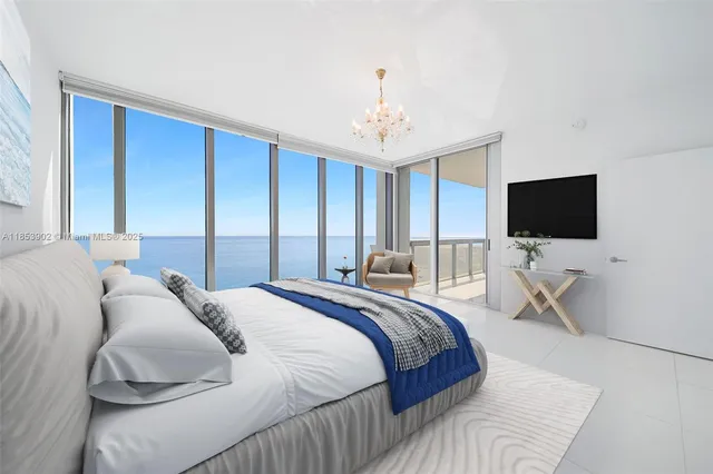 a bedroom with a bed tv and a window