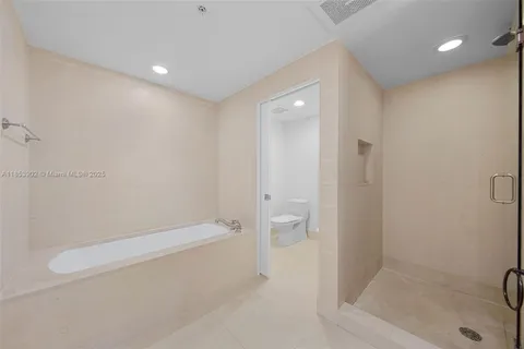 a bathroom with a shower and toilet