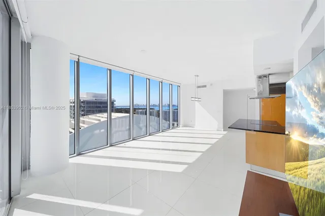 a large white bed in a white room