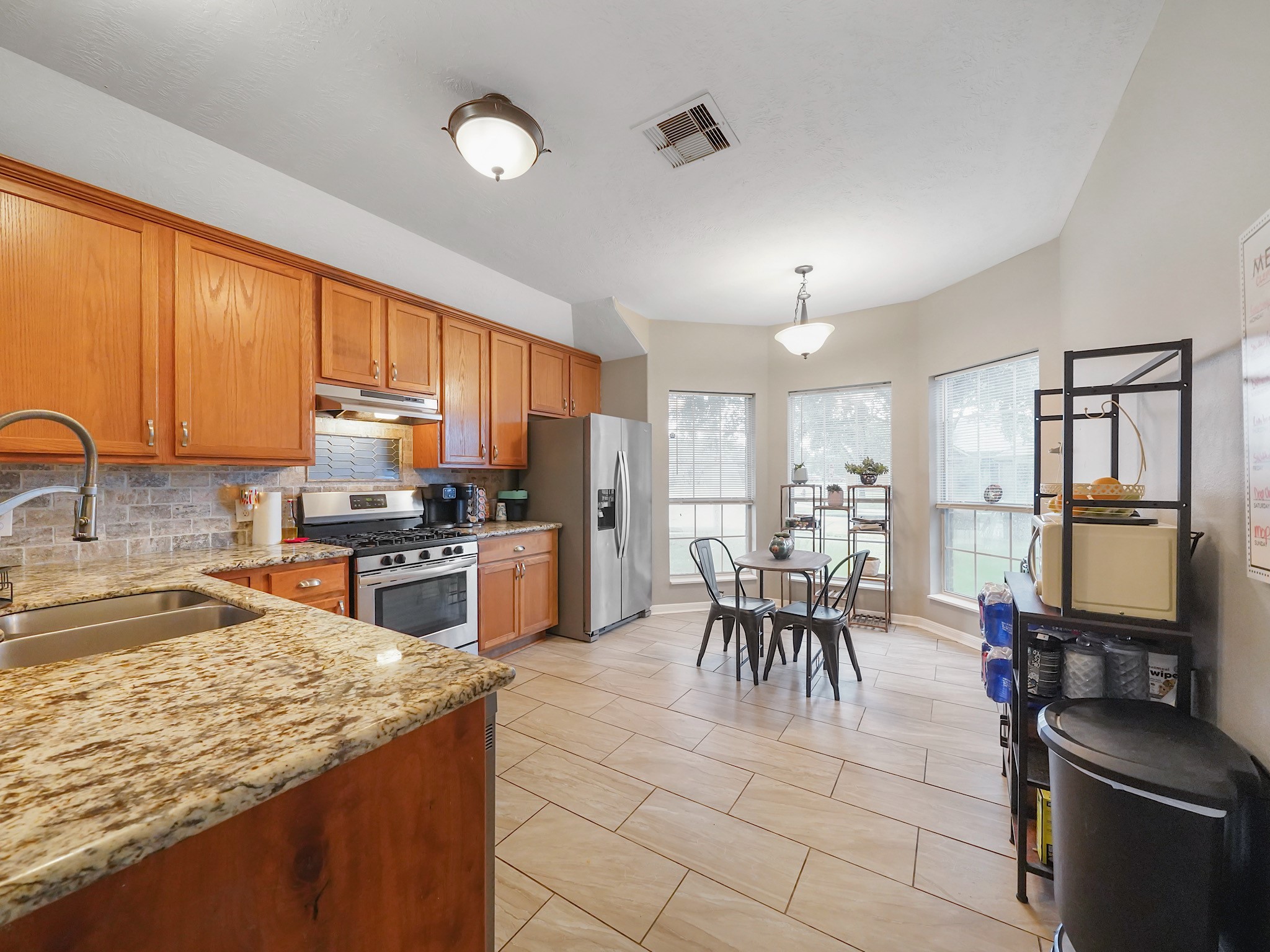 4006 Raspberry Court Dickinson, TX 77539 - Photo 5 of 22 a kitchen with granite countertop a stove oven and sink
