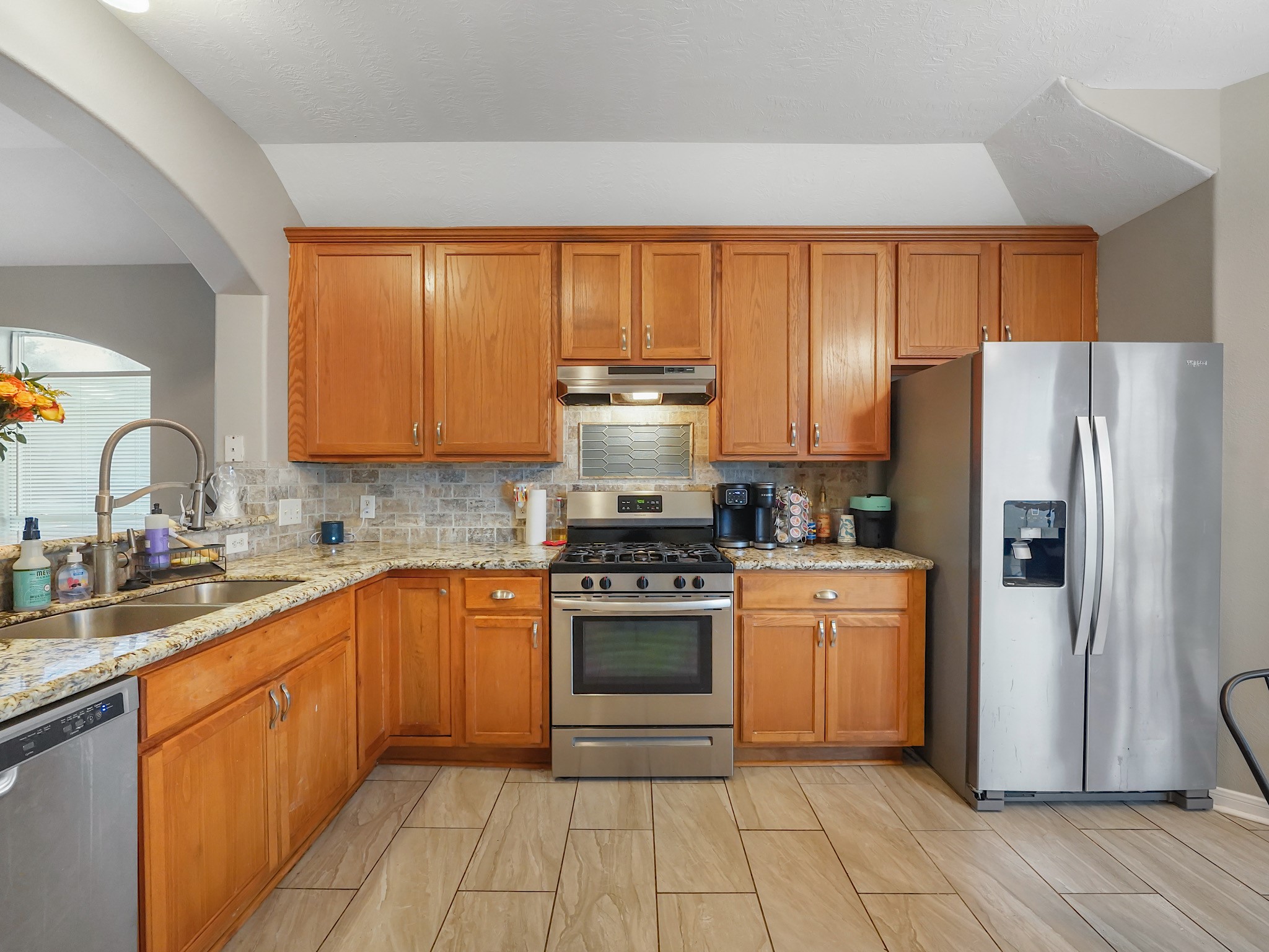 4006 Raspberry Court Dickinson, TX 77539 - Photo 7 of 22 a kitchen with a stove a sink and a refrigerator
