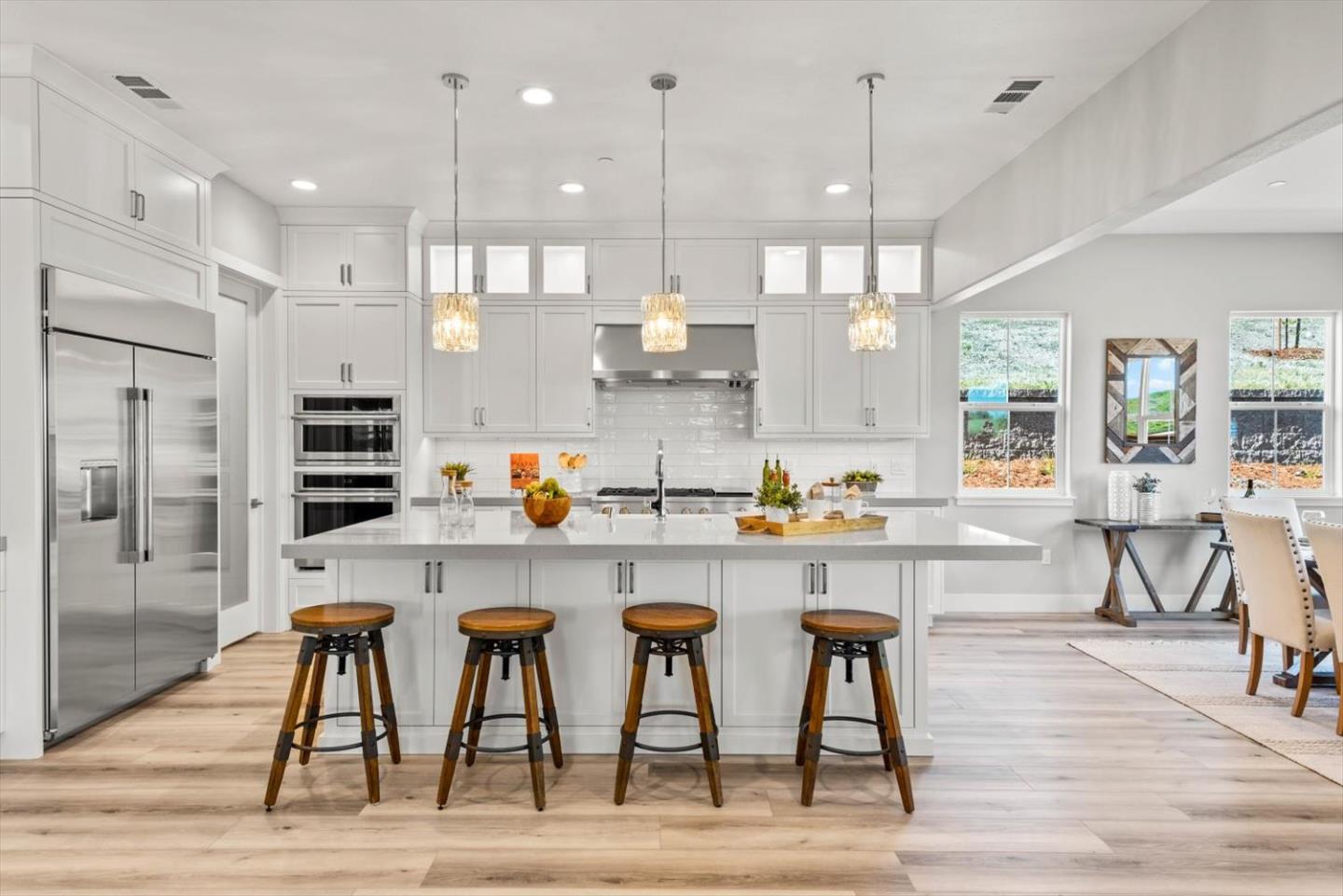 9515 Faria Preserve Parkway San Ramon, CA 94583 - Photo 21 of 84 a kitchen with stainless steel appliances granite countertop a table chairs refrigerator and microwave