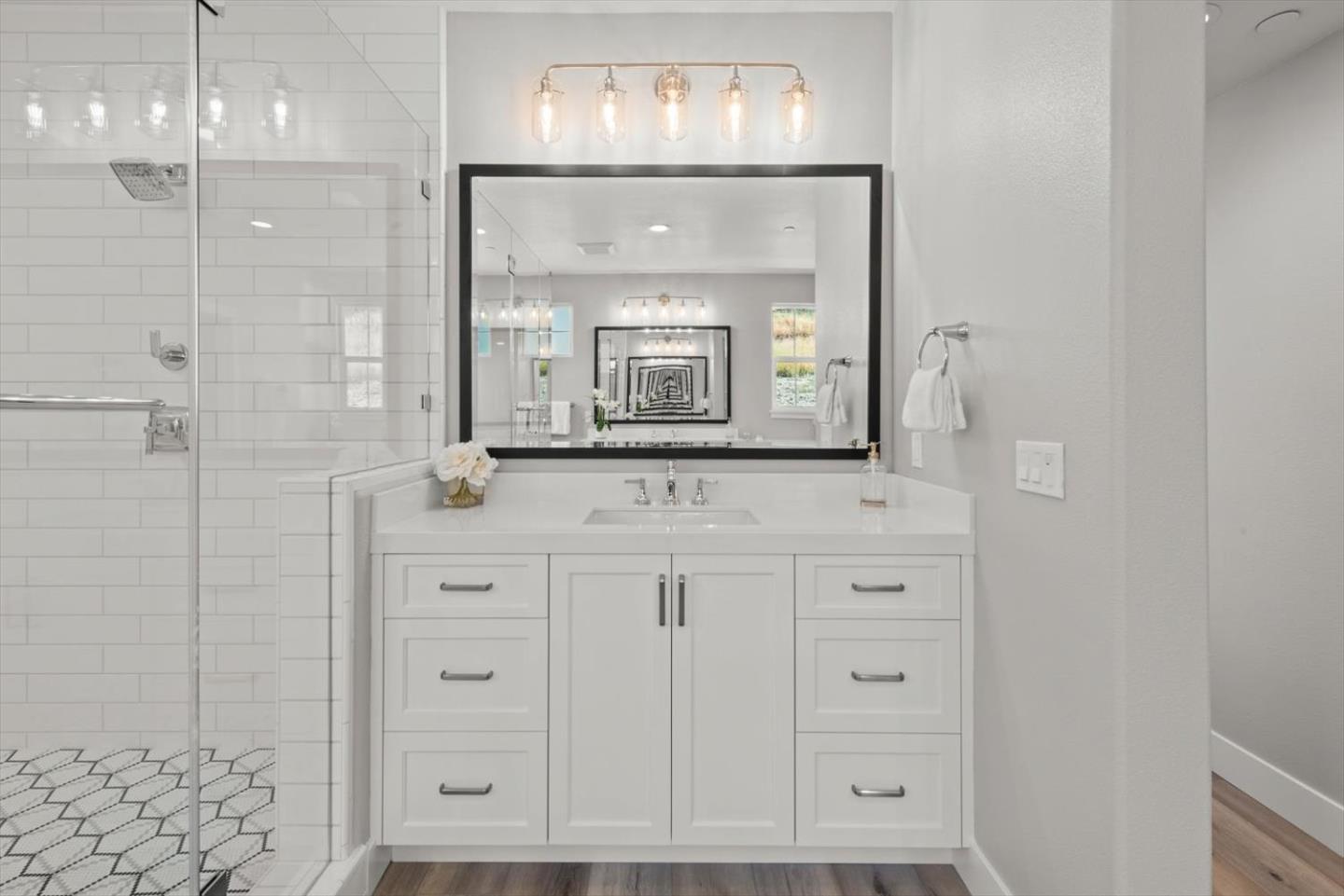 9515 Faria Preserve Parkway San Ramon, CA 94583 - Photo 61 of 84 a bathroom with a granite countertop sink mirror and vanity