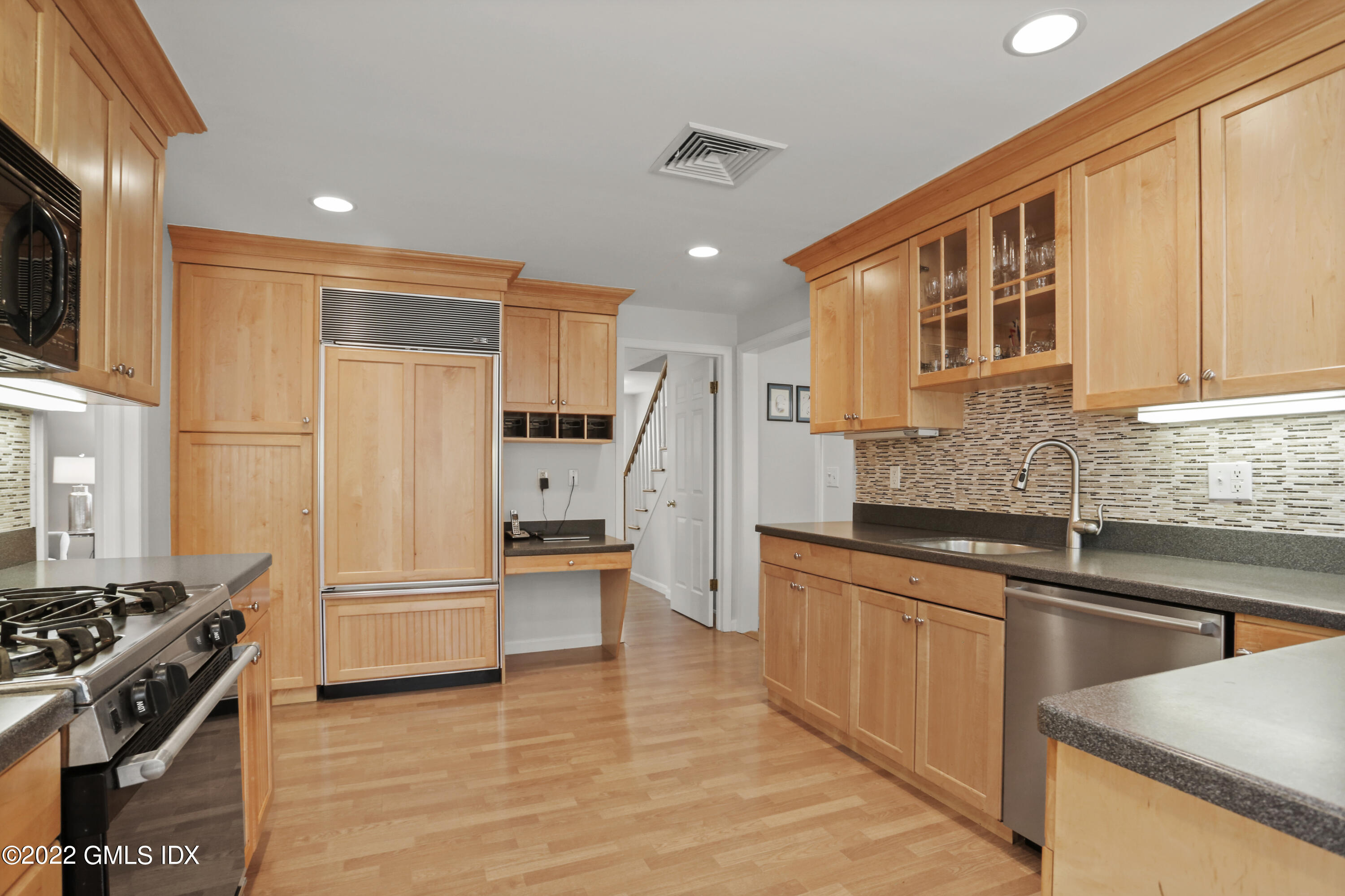 33 Revere Road Riverside, CT 06878 - Photo 8 of 32 a kitchen with stainless steel appliances granite countertop a refrigerator and a stove top oven