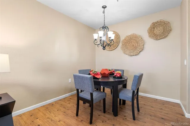 a view of a dining room with furniture and chandelier