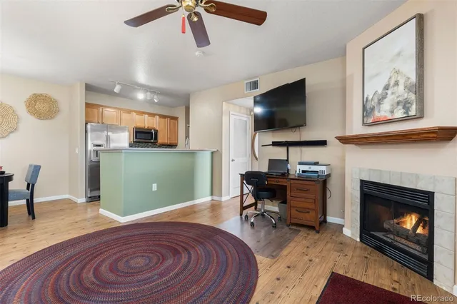 a living room with furniture and a fireplace