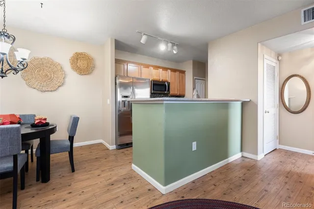 a kitchen with cabinets and wooden floor