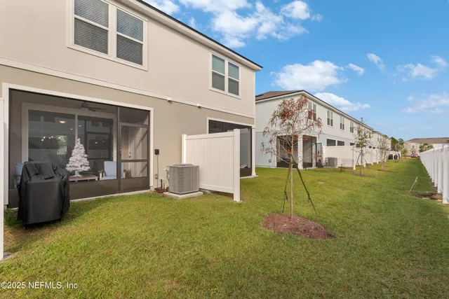 a view of a house with backyard and porch