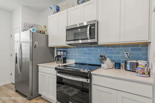 a kitchen with a stove and a microwave