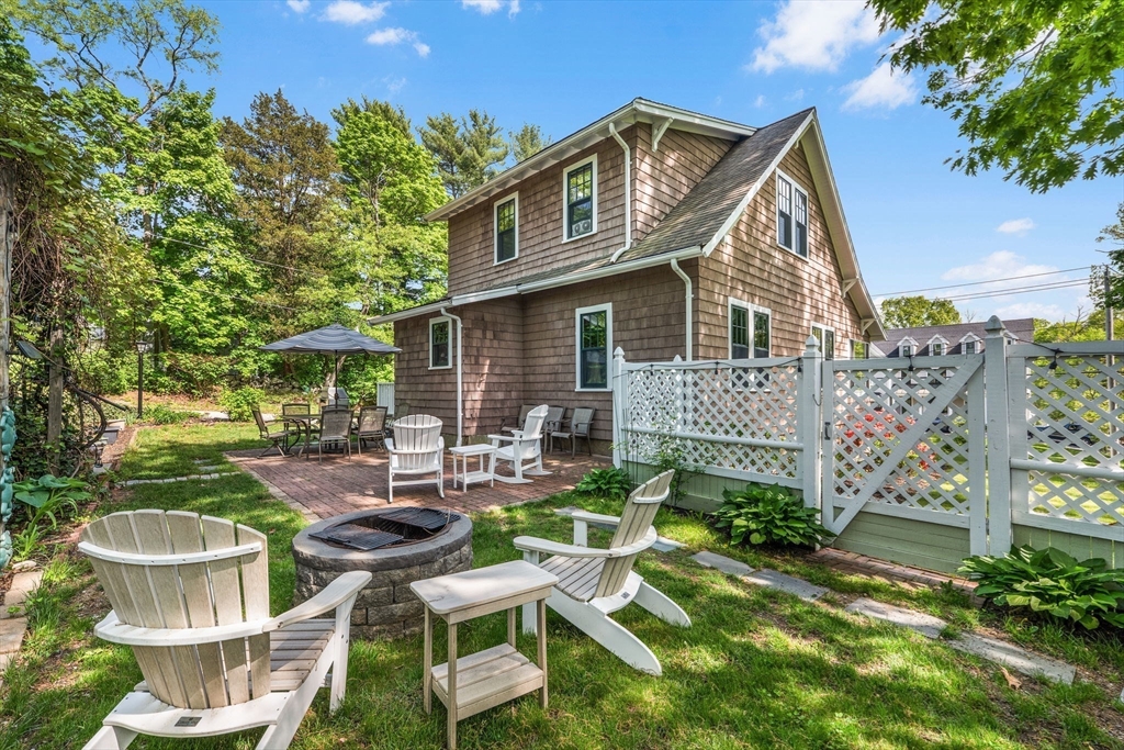 296 North Main Street Cohasset, MA 02025 - Photo 17 of 27 a view of a patio with table and chairs potted plants and a large tree