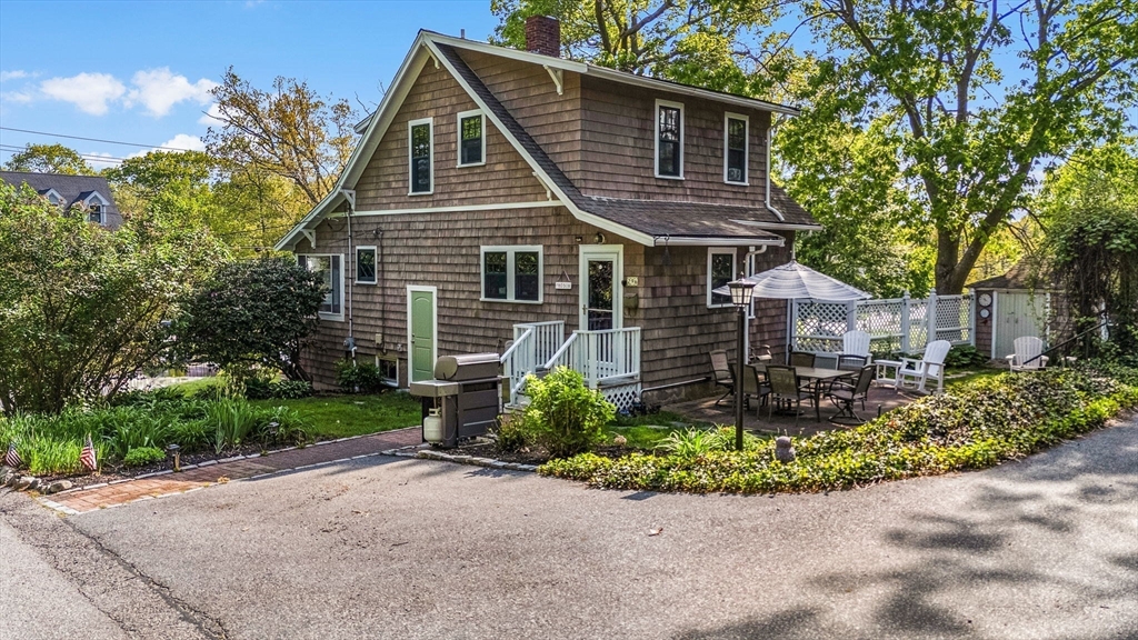 296 North Main Street Cohasset, MA 02025 - Photo 19 of 27 a front view of a house with a garden and plants
