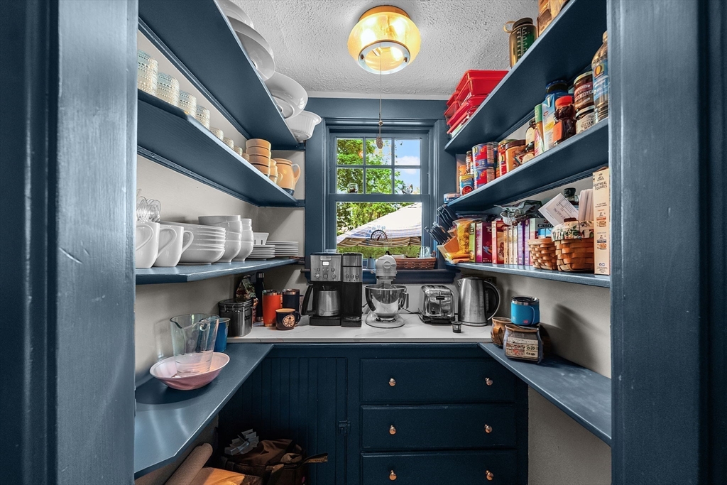 296 North Main Street Cohasset, MA 02025 - Photo 4 of 27 a room with lots of books and a large mirror