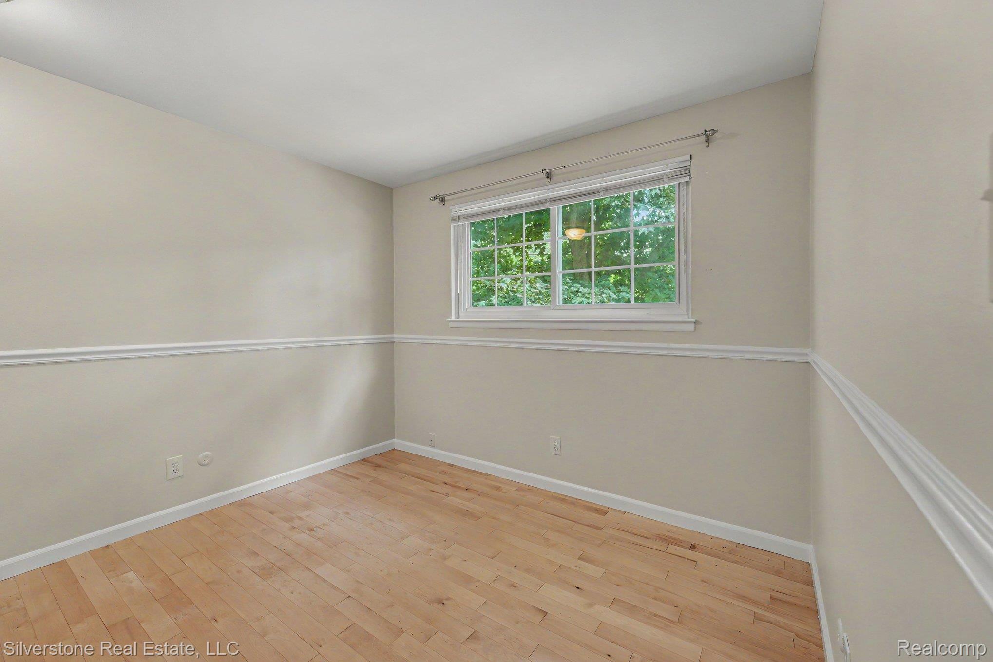 547 Reed Street Northville, MI 48167 - Photo 17 of 38 Hardwood-finish flooring complements neutral wall tones and white trim