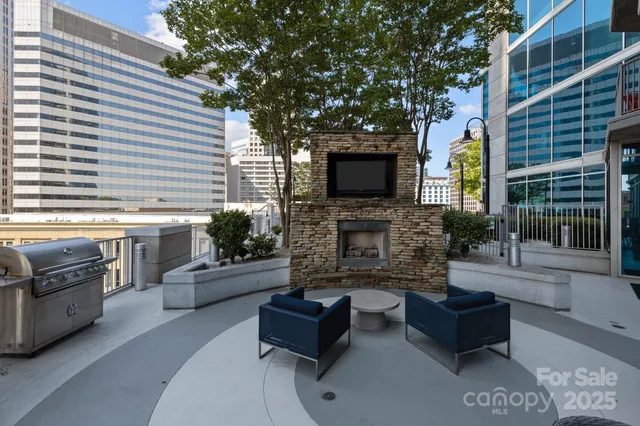 a living room with furniture a flat screen tv and a large window