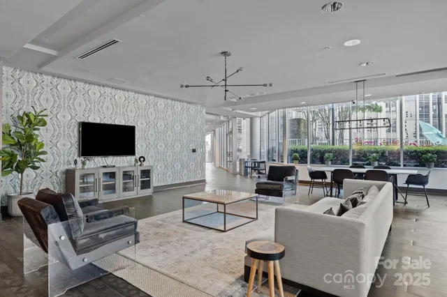 a living room with a table and a flat screen tv