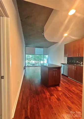 a view of a room with wooden floor