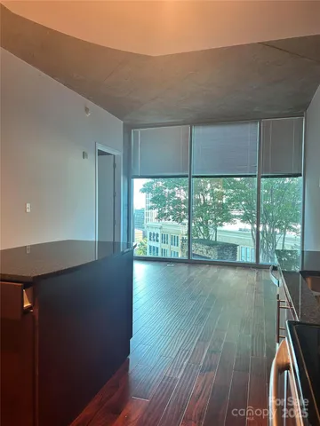 a view of a room with wooden floor and outdoor space