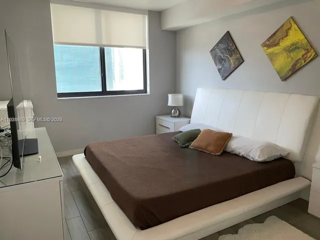 a bedroom with a bed and window