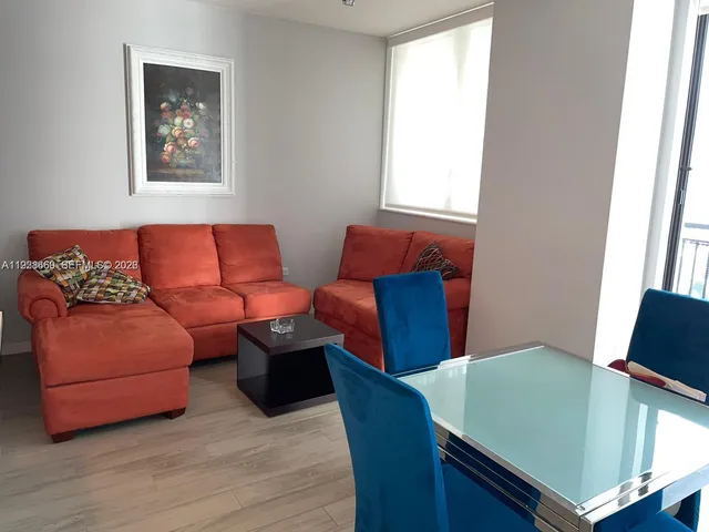 a living room with furniture and a window