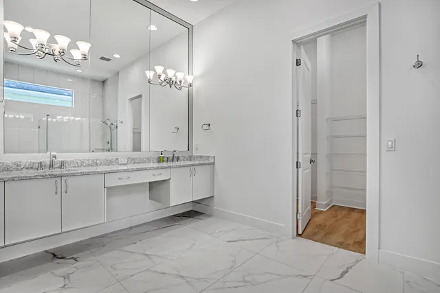 a bathroom with a double vanity sink mirror and a shower