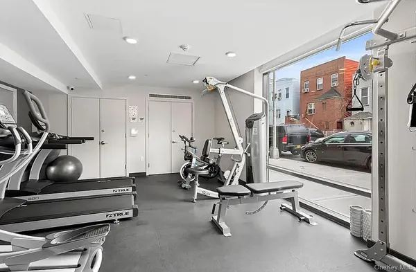 a room with gym equipment and windows
