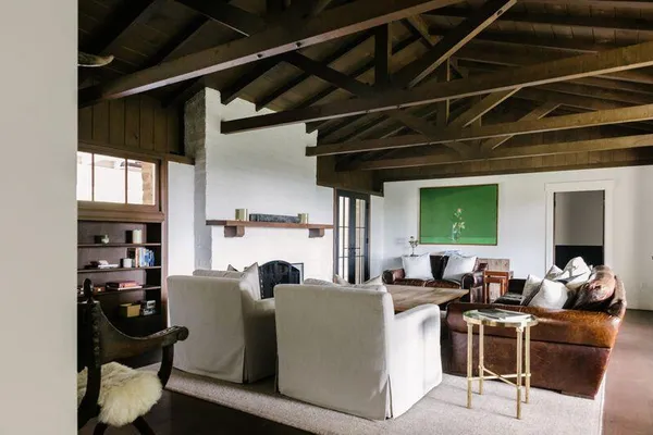 a living room with furniture a fireplace and a table