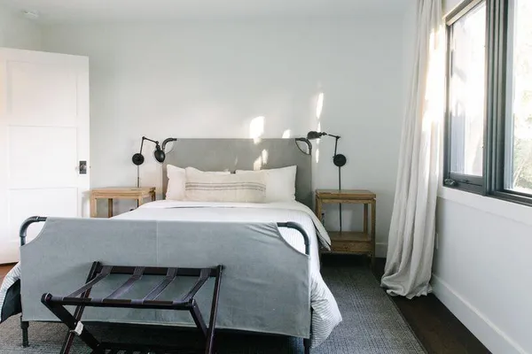 a bedroom with a bed a table and chair