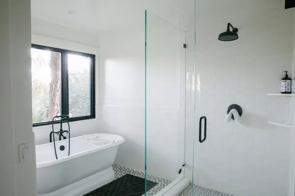 a view of bathroom with bathtub and window