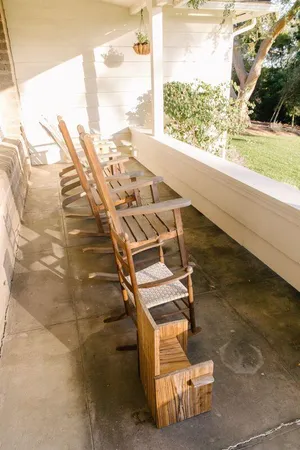 a view of a house with a yard and sitting area