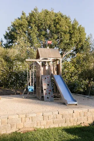 a view of a patio with a table and chairs