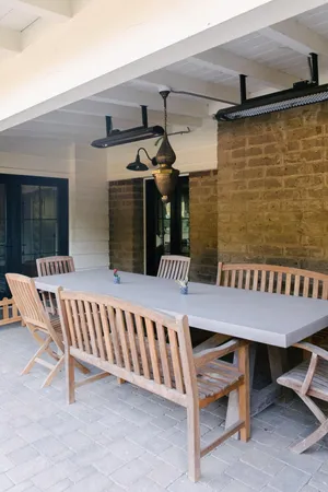 a living room with couches and balcony view with wooden floor