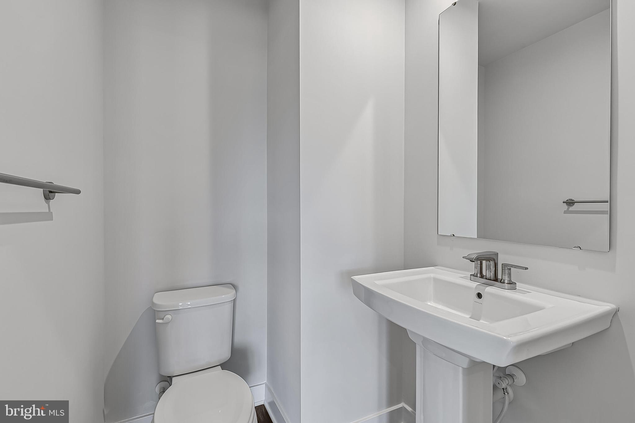 1201 Oasis Avenue Ranson, WV 25438 - Photo 7 of 38 a bathroom with a sink a toilet and a mirror