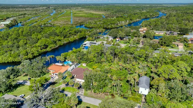 a view of a lake with a flower garden