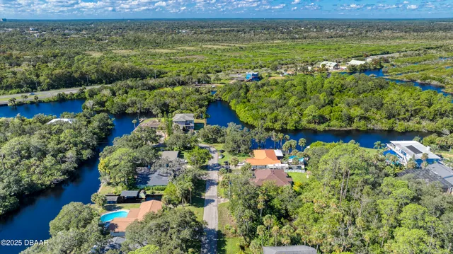 an aerial view of a house with a yard
