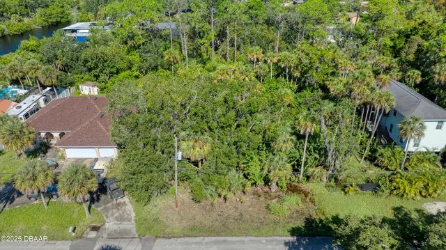 an aerial view of a house with yard